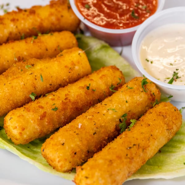 Golden-brown mozzarella sticks, garnished with parsley, served on lettuce with marinara and ranch dipping sauces.